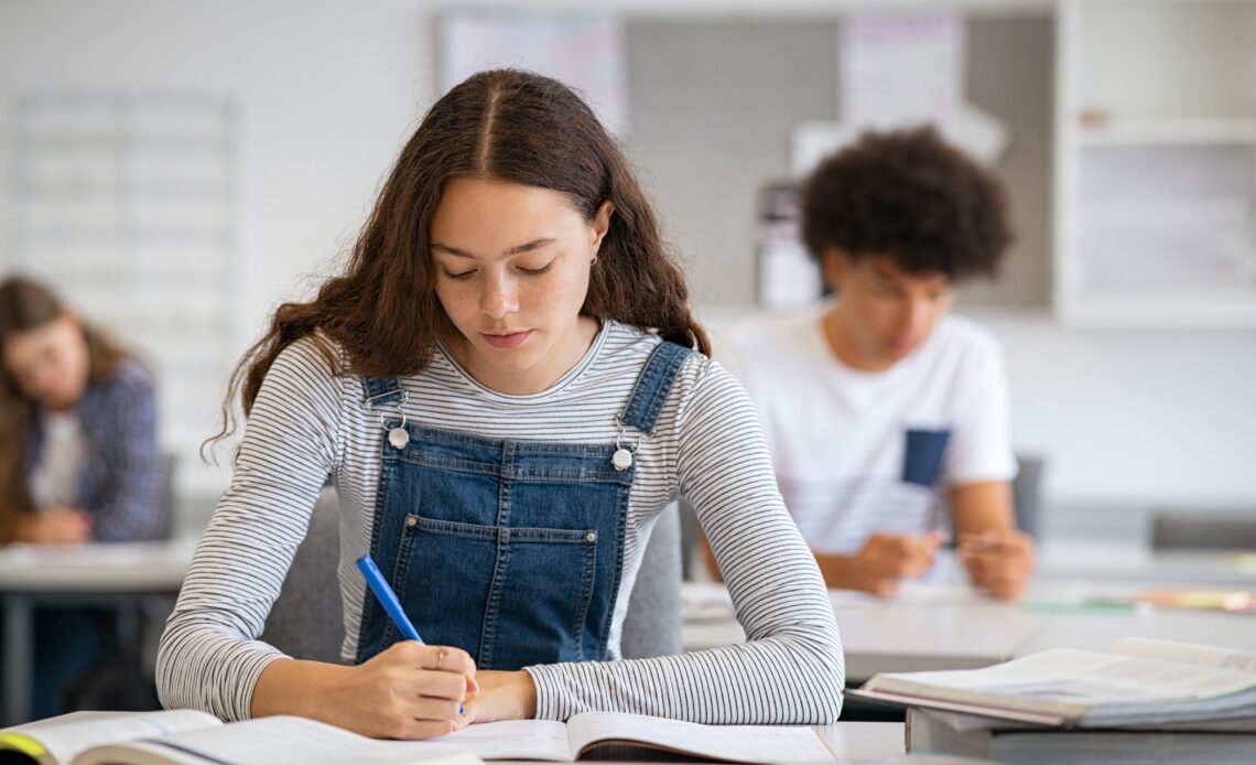College girl studying with concentration in class