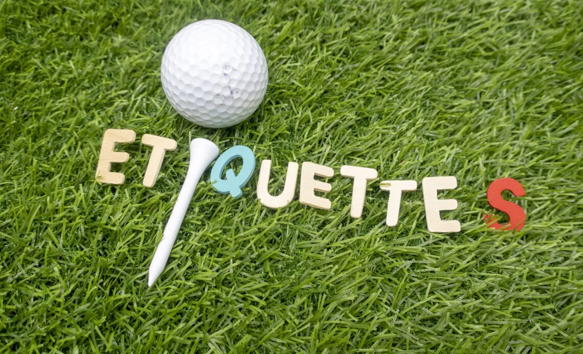 etiquette word on green grass with golf ball