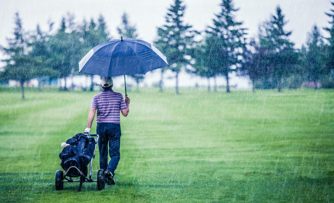 Golfer on a Rainy Day Leaving the Golf Course