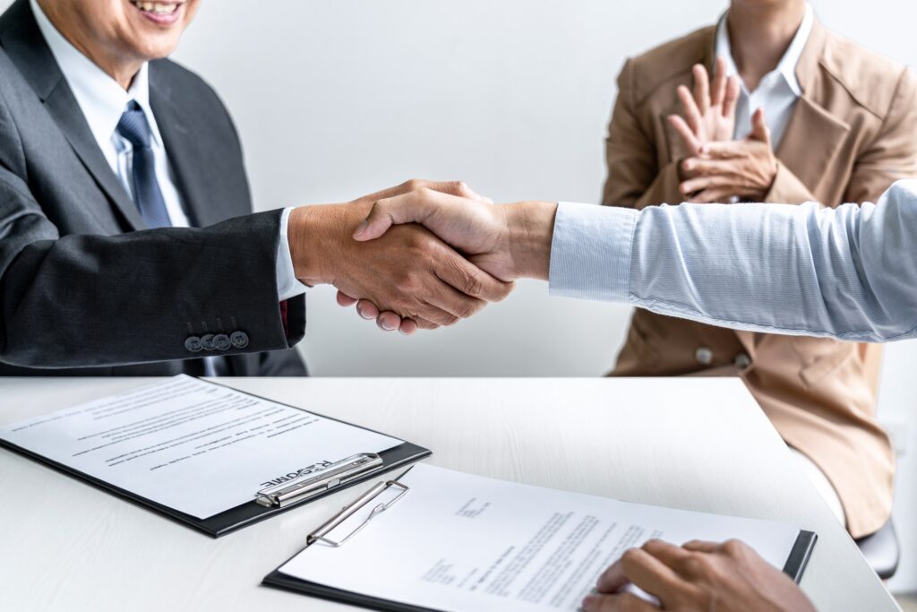 male candidate shaking hands with Interviewer or employer after a job interview
