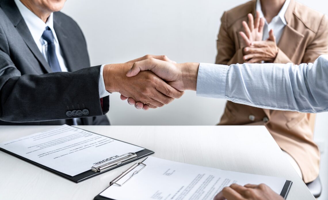 male candidate shaking hands with Interviewer or employer after a job interview