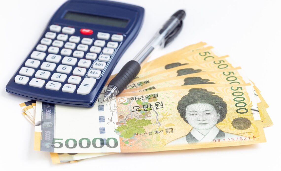 South Korea currency 50 000 won value with pen and calculator, save money concept