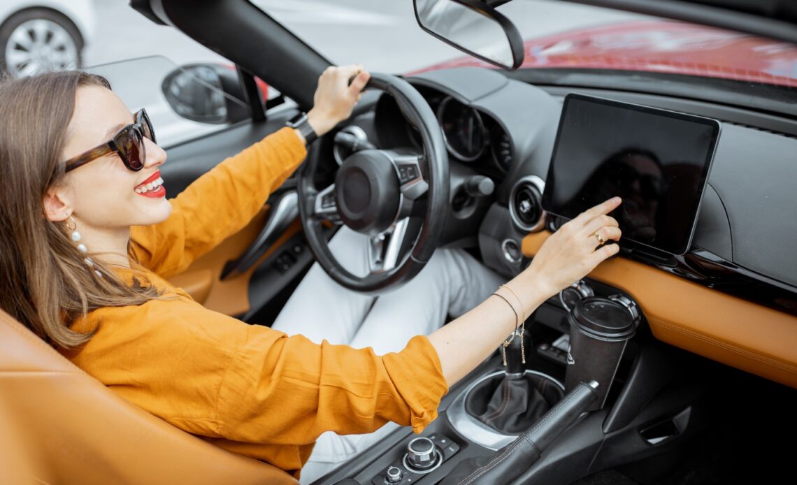 Woman controlling car with a digital dashboard