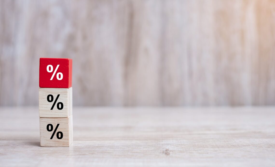 wood cube block with percentage symbol icon. Interest rate, financial, ranking and mortgage rates