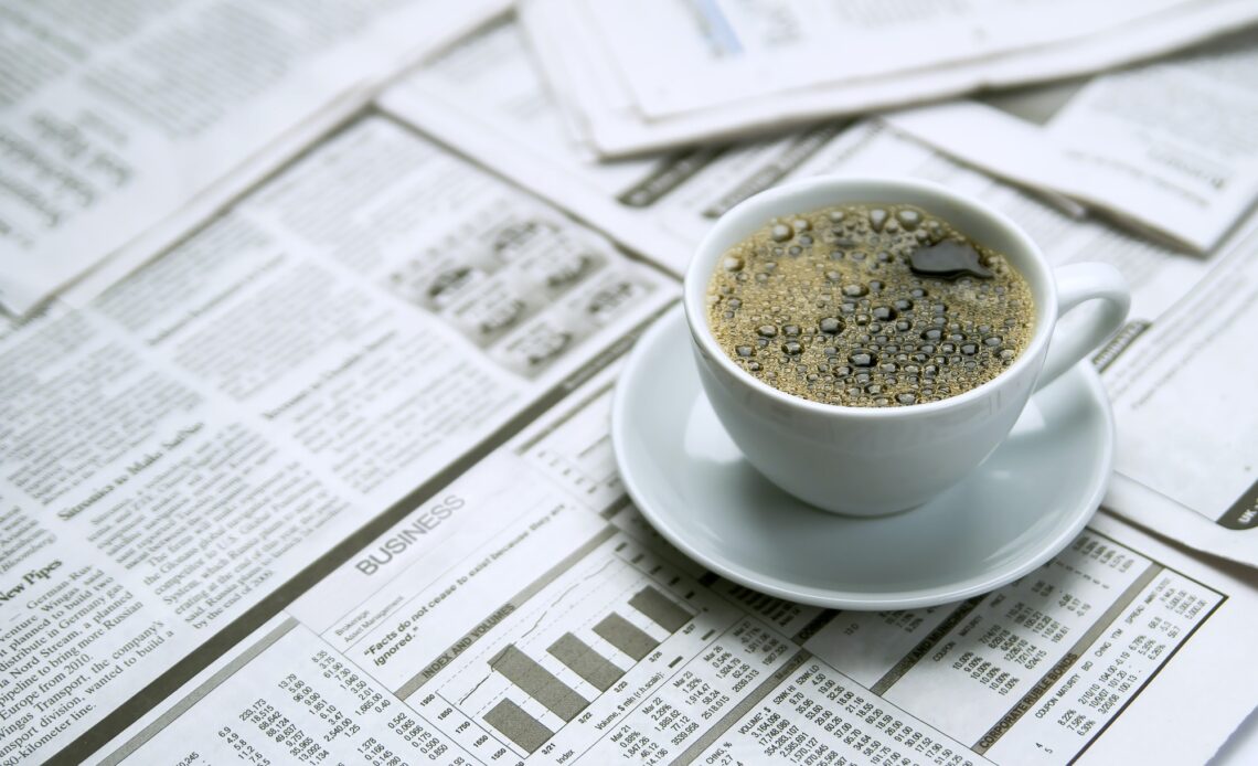 Coffee over newspaper