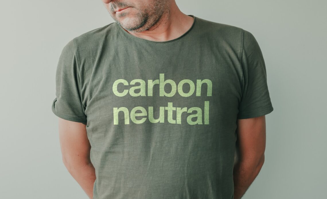 Man wearing green t-shirt with Carbon neutral text